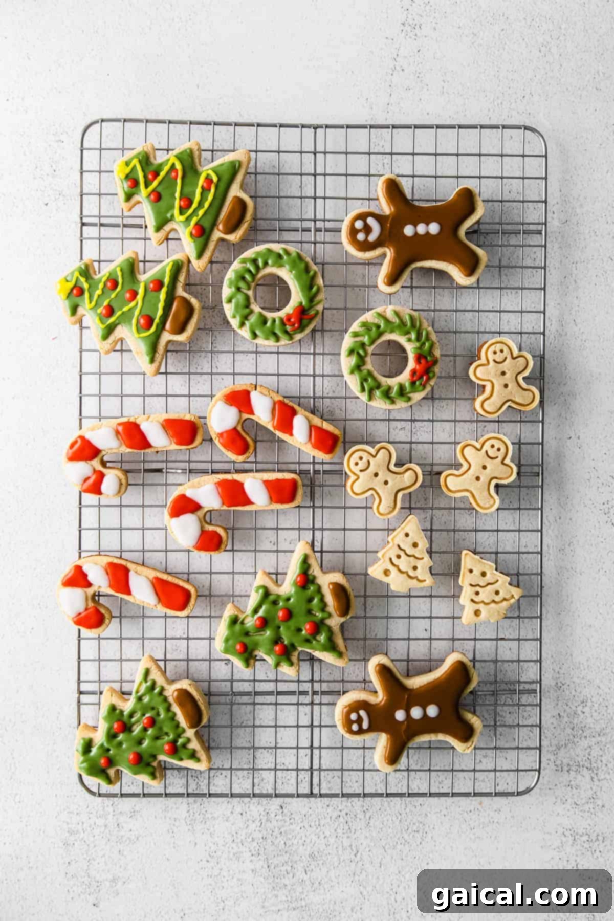 Decorated Grain-Free Holiday Sugar Cookies Assortment of beautifully decorated almond flour sugar cookies on a wire rack, showcasing various holiday themes and icing colors.