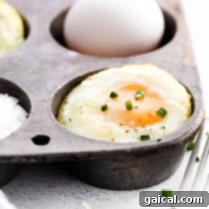 Perfectly baked eggs in a muffin tin, ready for a healthy breakfast.