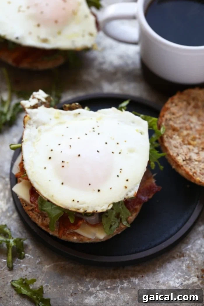 The ultimate Arugula Breakfast Sandwich with Caramelized Onions, a perfectly balanced and savory start to any day.