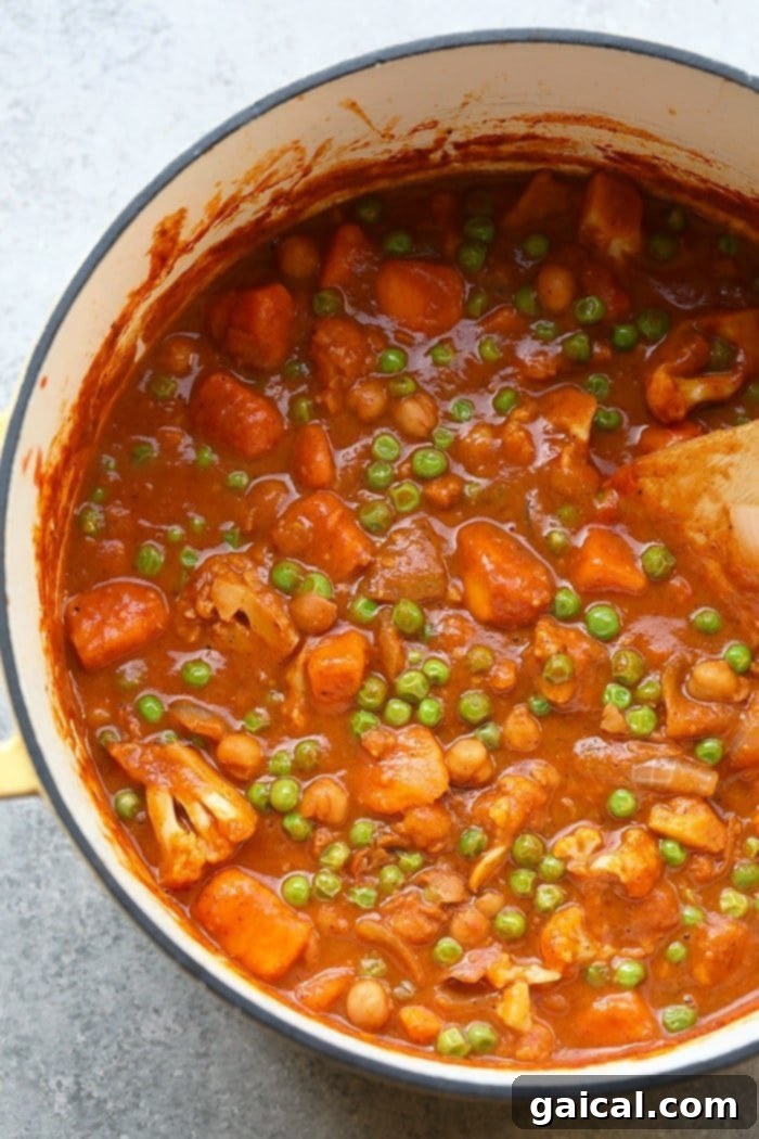 One-Pot Cauliflower Tikka Masala Cauliflower Tikka Masala simmering in a rustic dutch oven.