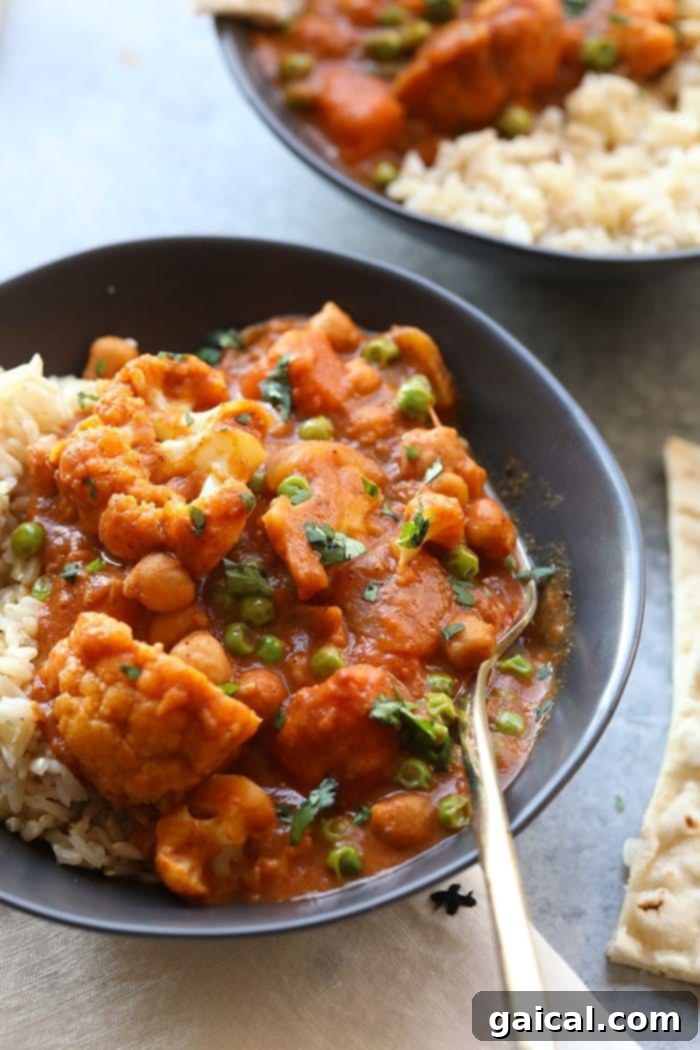Hearty Cauliflower Tikka Masala Close-up of Cauliflower Tikka Masala in a bowl, showcasing its vibrant color and hearty ingredients.