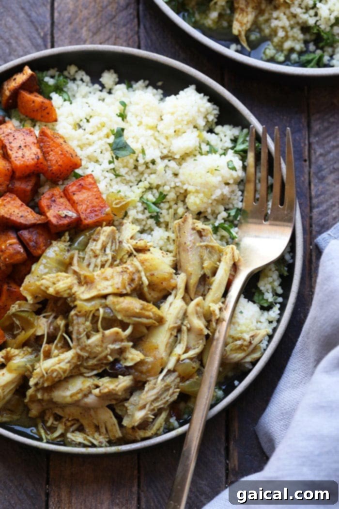 Plated Moroccan Chicken with couscous, sweet potatoes, and fresh herbs