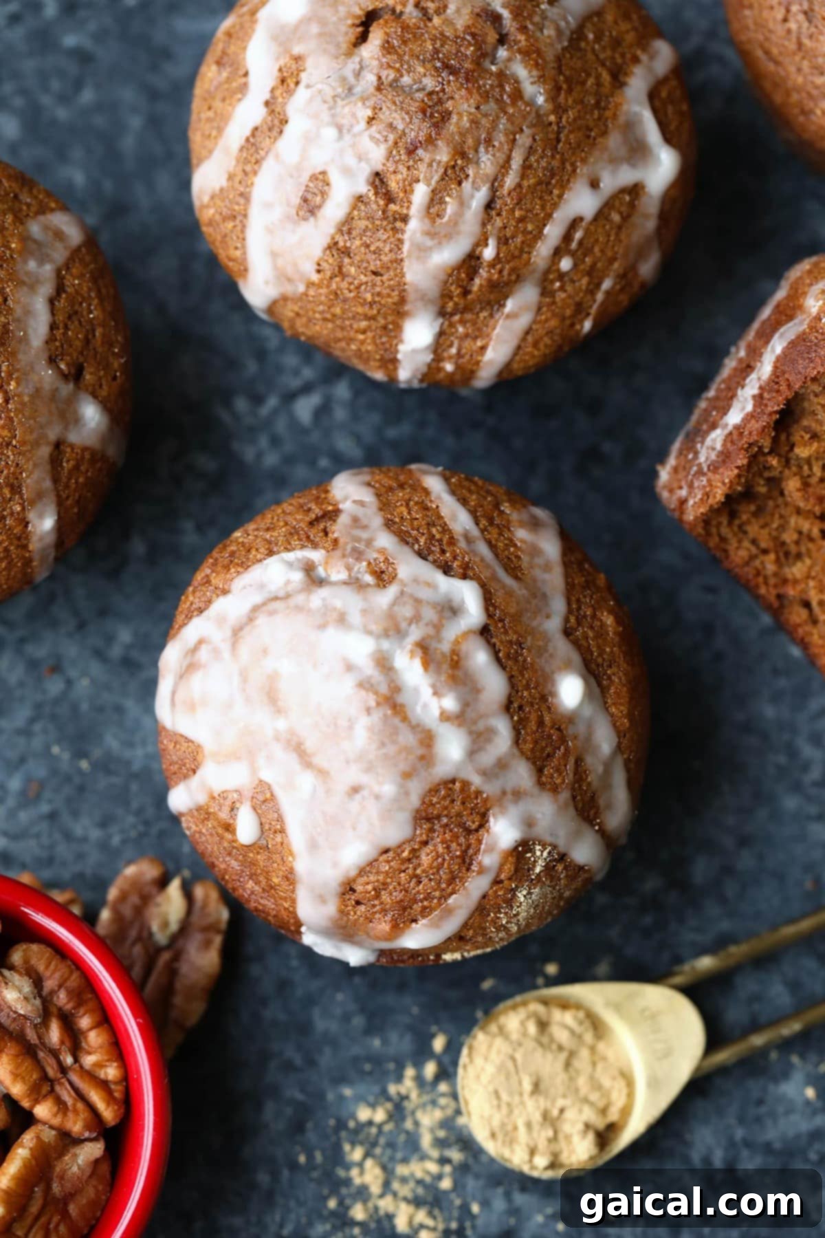 Healthy Gingerbread Muffins with Glaze A batch of healthy, golden-brown gingerbread muffins with a light glaze and chopped pecans.