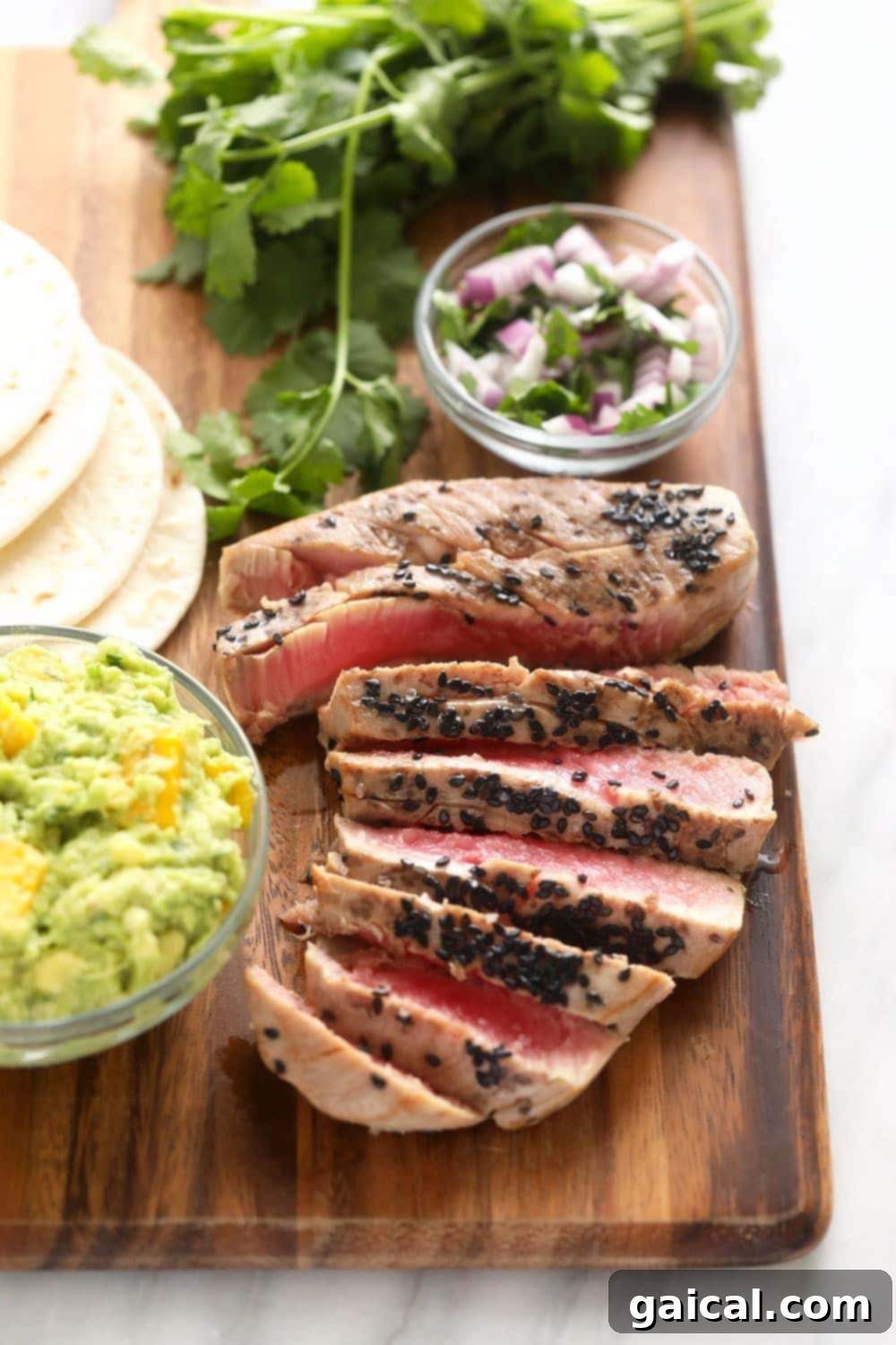 Sliced Seared Ahi Tuna Perfectly sliced seared ahi tuna showing its rare, pink center, ready for taco assembly.