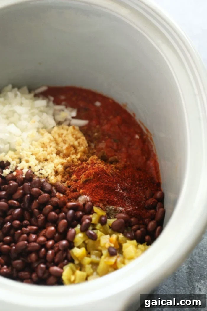 Slow Cooker Black Bean Soup Crock pot black bean soup simmering in a slow cooker, showcasing the rich, dark texture of the beans and vegetables.