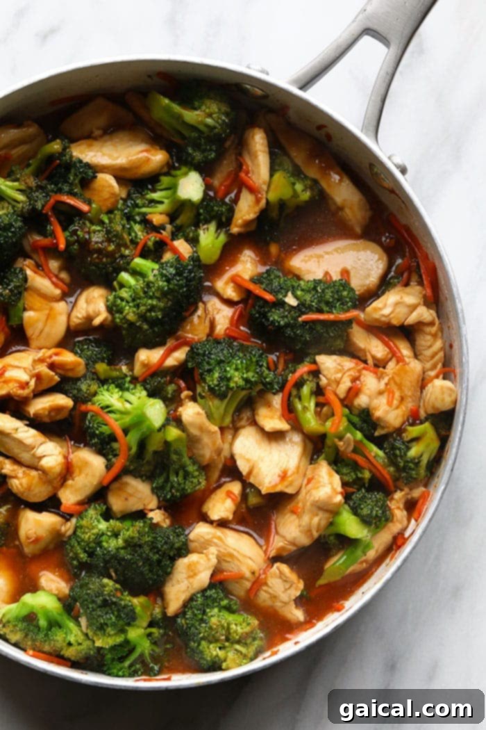 Quick and Easy Chicken Stir Fry 4 Sizzling chicken and vibrant vegetables cooking together in a large wok or pan, coated in a glistening stir fry sauce.