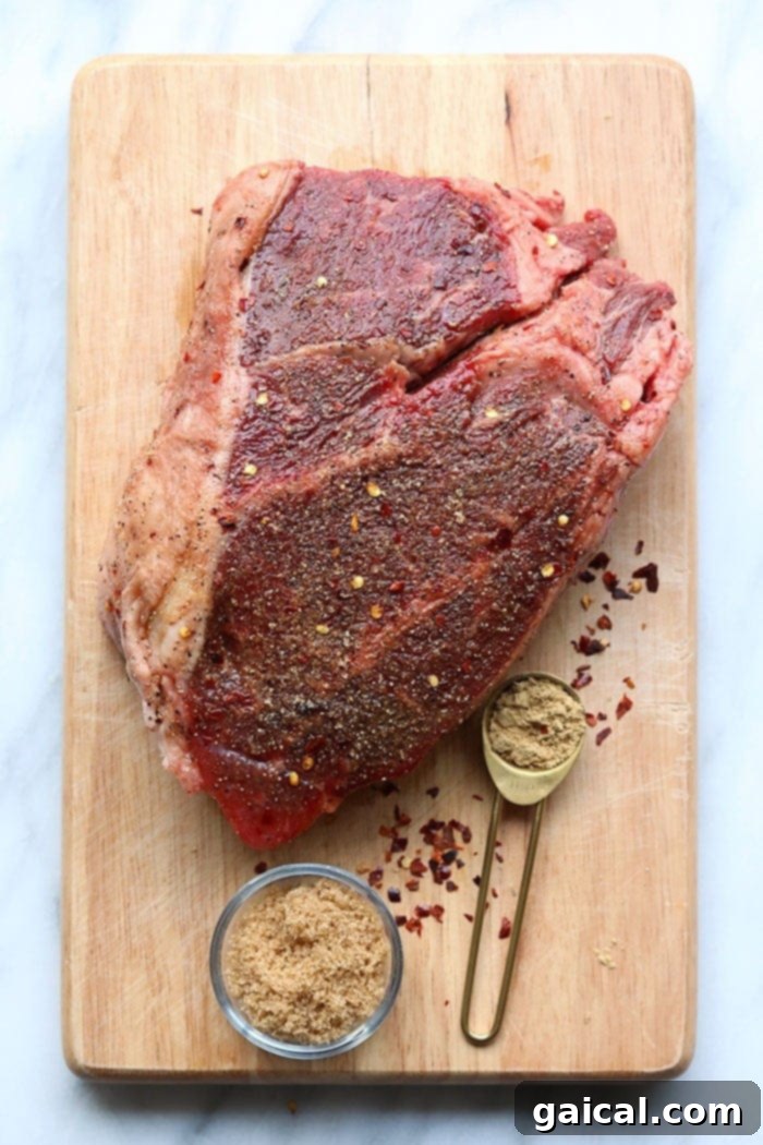 Chuck Roast for Instant Pot Recipes A raw chuck roast resting on a wooden cutting board, ready for seasoning.
