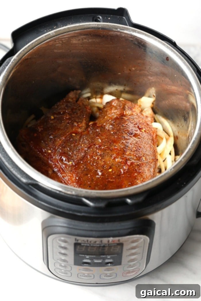 Instant Pot Korean Beef Cooking Process Instant Pot filled with Korean Beef and sauce, ready to be cooked.