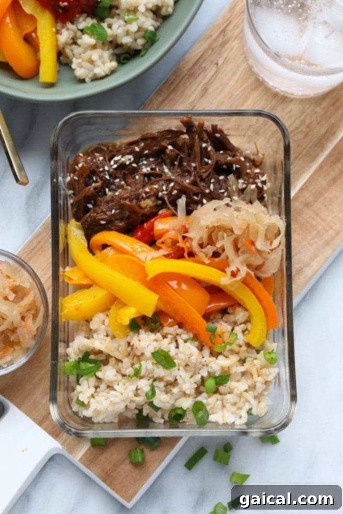 Effortless Instant Pot Korean Beef Bowls 2 A beautifully assembled Instant Pot Korean Beef Bowl with rice, peppers, and toppings.