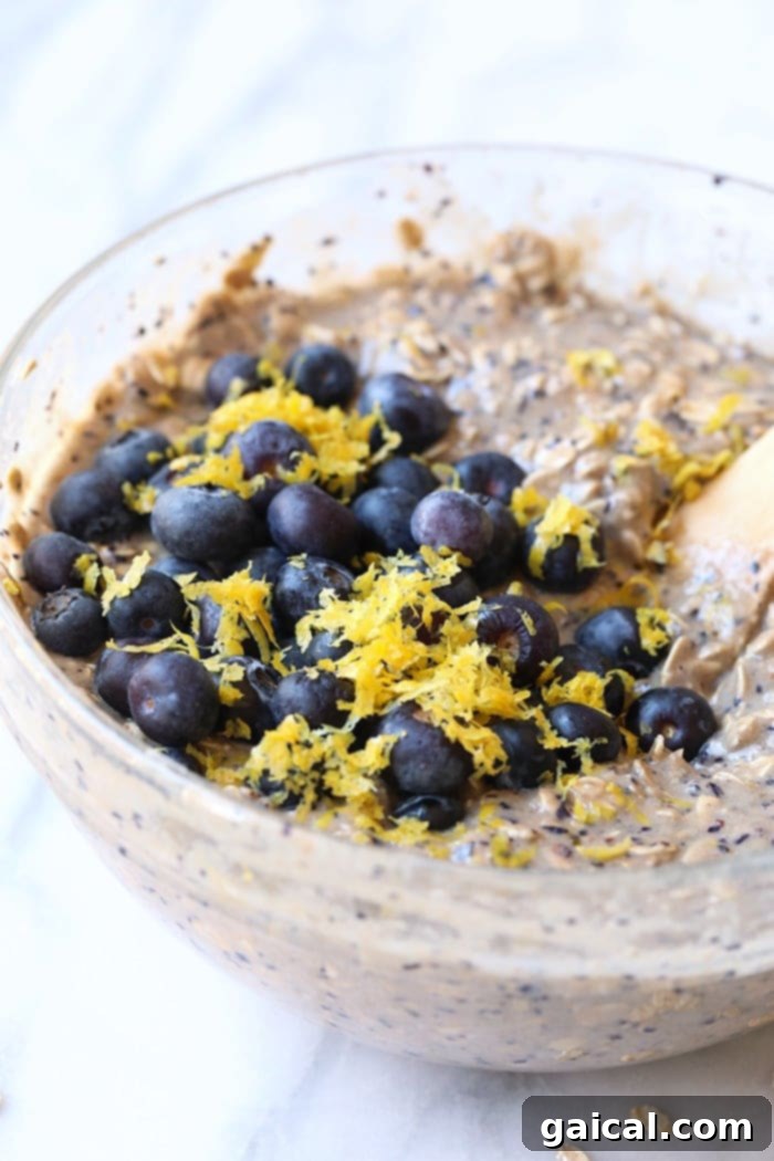 This delicious lemon blueberry baked oatmeal recipe screams spring with the combination of fresh blueberries and lemon zest. This delicious vegan oatmeal bake is made in under an hour and has 100% whole grains and no r Bowl of Lemon Blueberry Baked Oatmeal