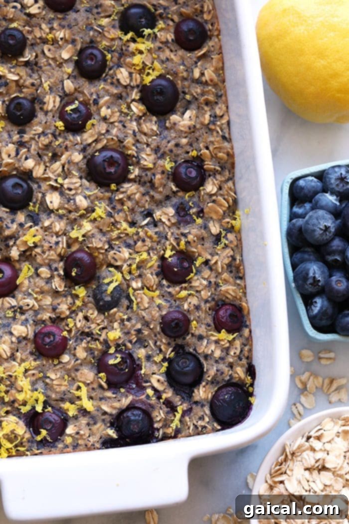 This delicious lemon blueberry baked oatmeal recipe screams spring with the combination of fresh blueberries and lemon zest. This delicious vegan oatmeal bake is made in under an hour and has 100% whole grains and no r Lemon Blueberry Baked Oatmeal topped with fresh berries