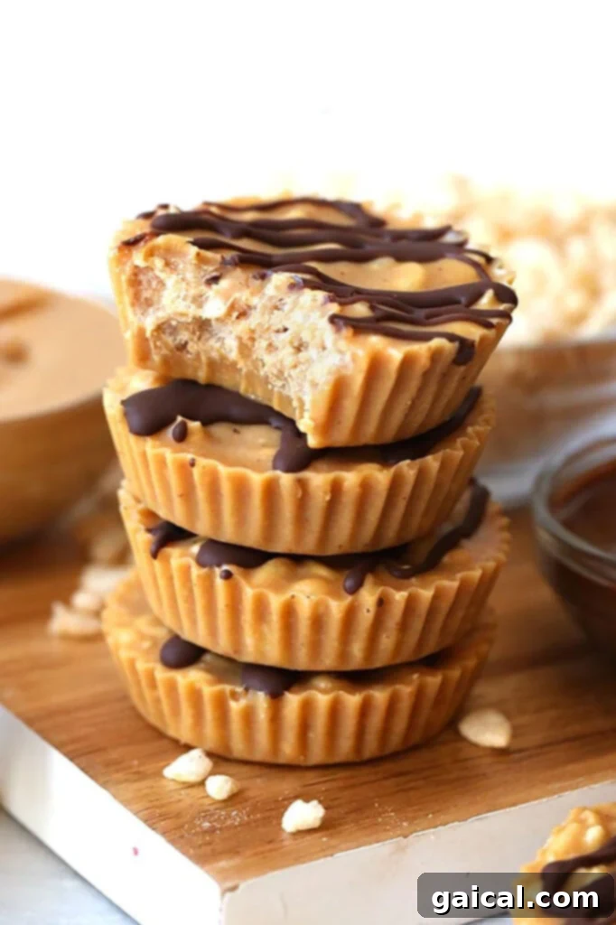 A stack of golden peanut butter crunch cups on a rustic wooden cutting board, showcasing their inviting texture.