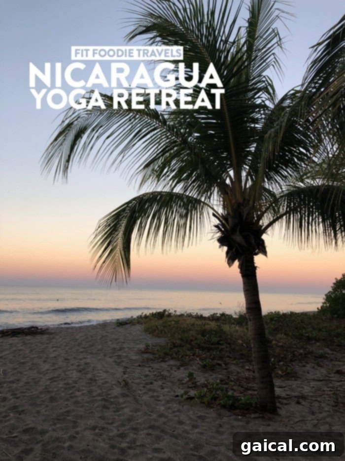 Fit Foodie Travels Nicaragua Yoga Adventure 2 A woman standing on a beach with a beautiful sunset in Nicaragua.