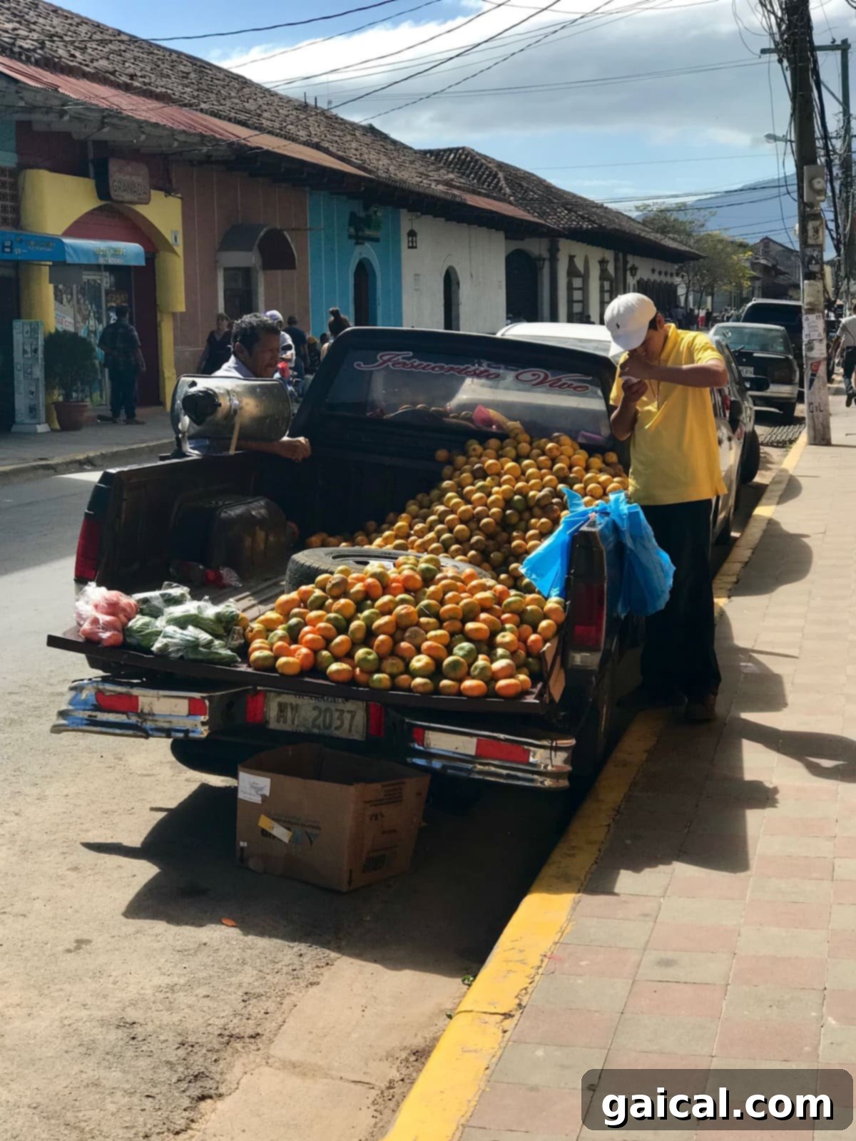 Here is a three-day guide to Granada, Nicaragua! A colorful truck laden with oranges, depicting a scene from a three-day travel guide to Granada, Nicaragua.