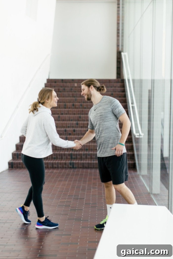 A couple performing a unique handshake, symbolizing their shared active lifestyle and connection.