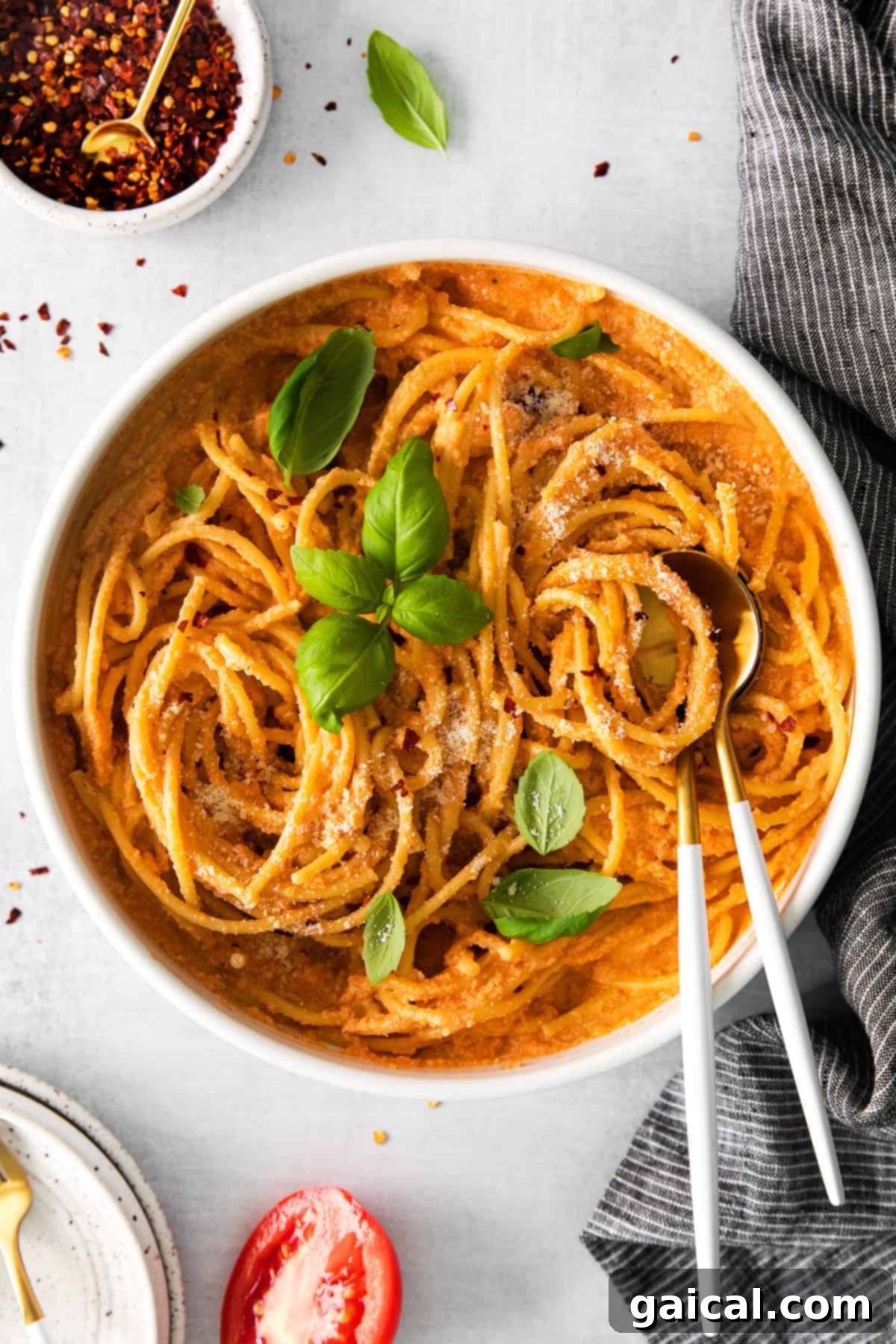 Delicious creamy vegan pasta in a bowl, garnished with fresh basil