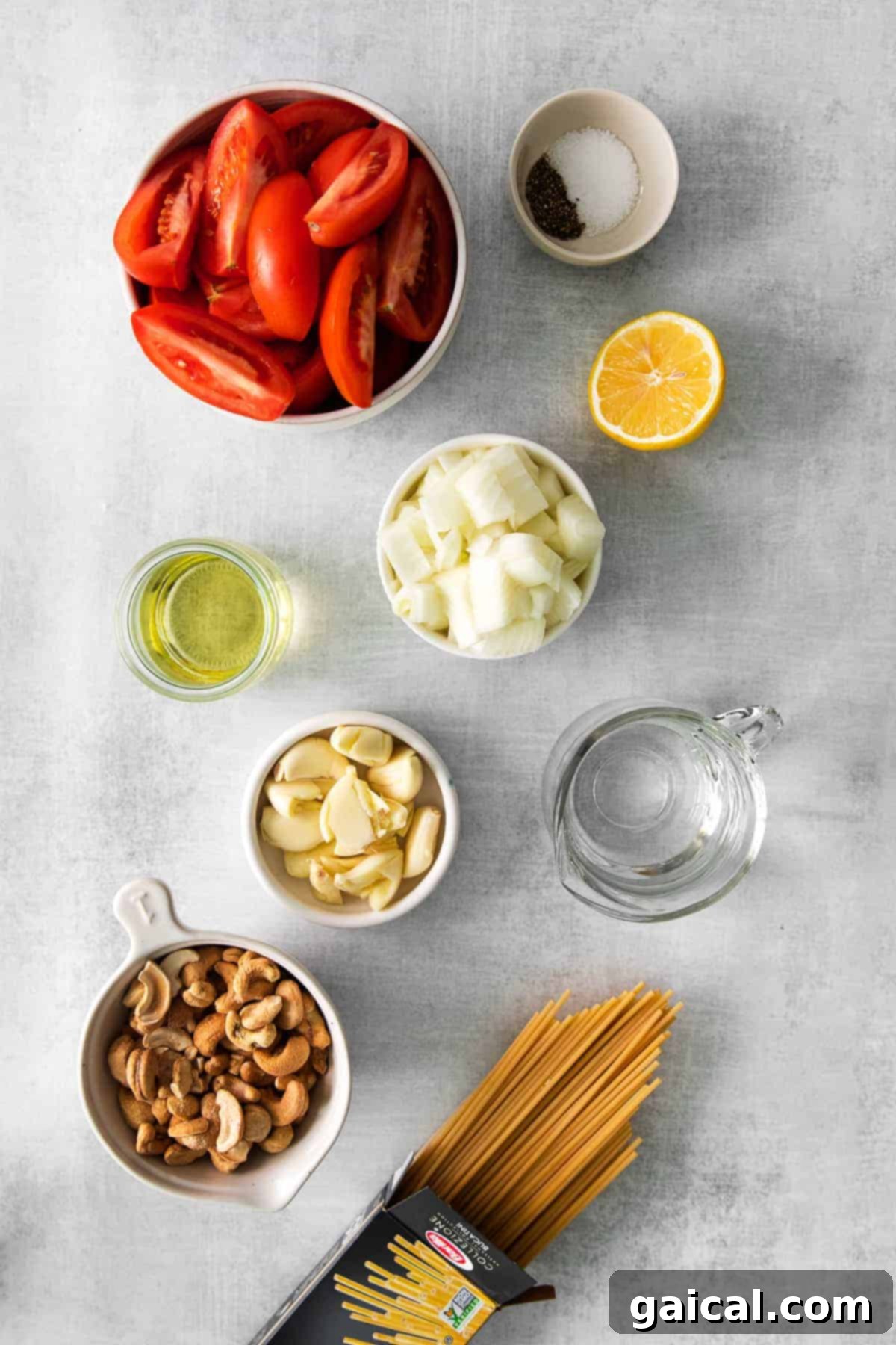 Fresh ingredients laid out on a kitchen counter for making creamy vegan pasta
