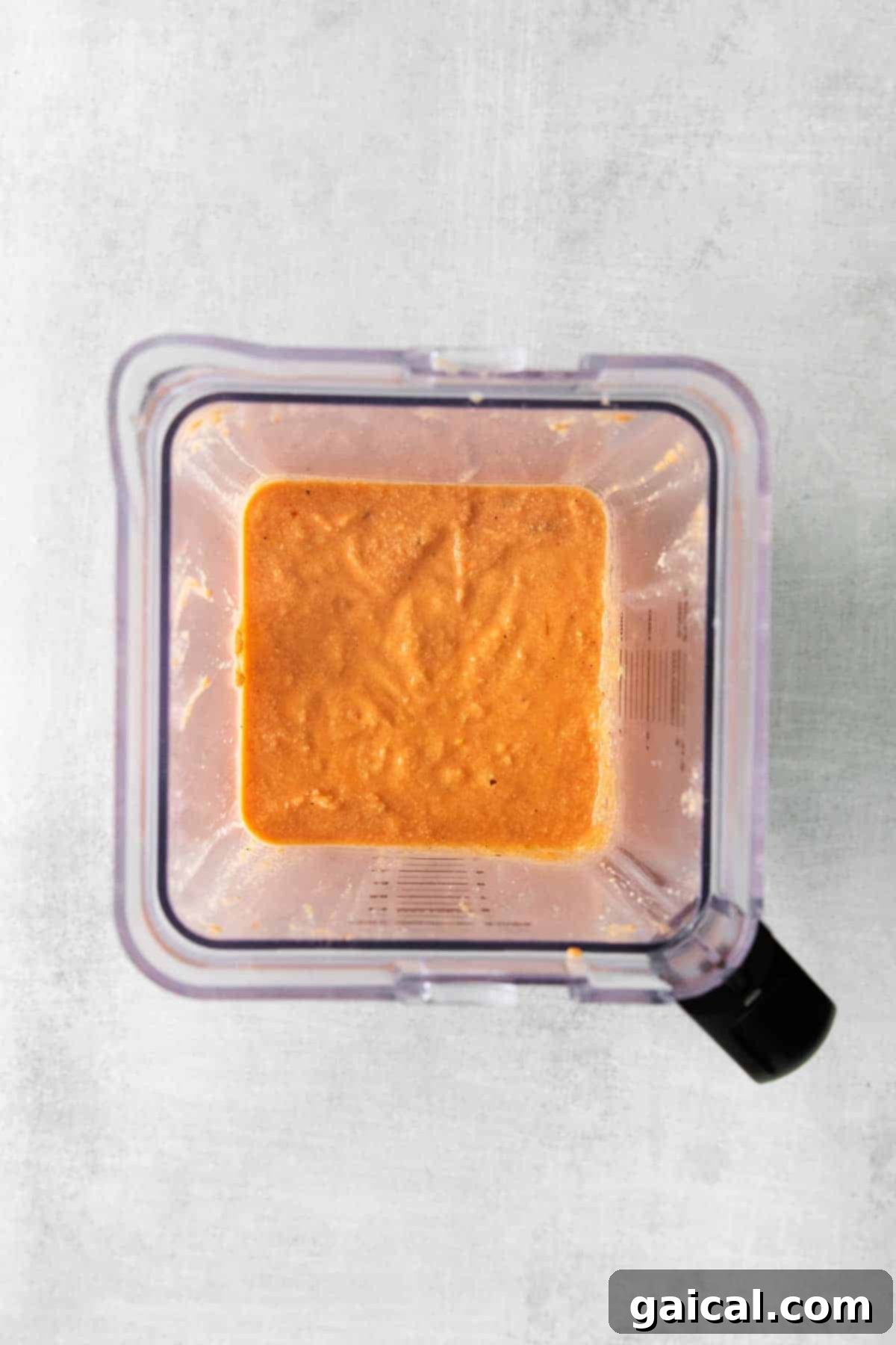 Creamy vegan pasta sauce blending in a high-speed blender