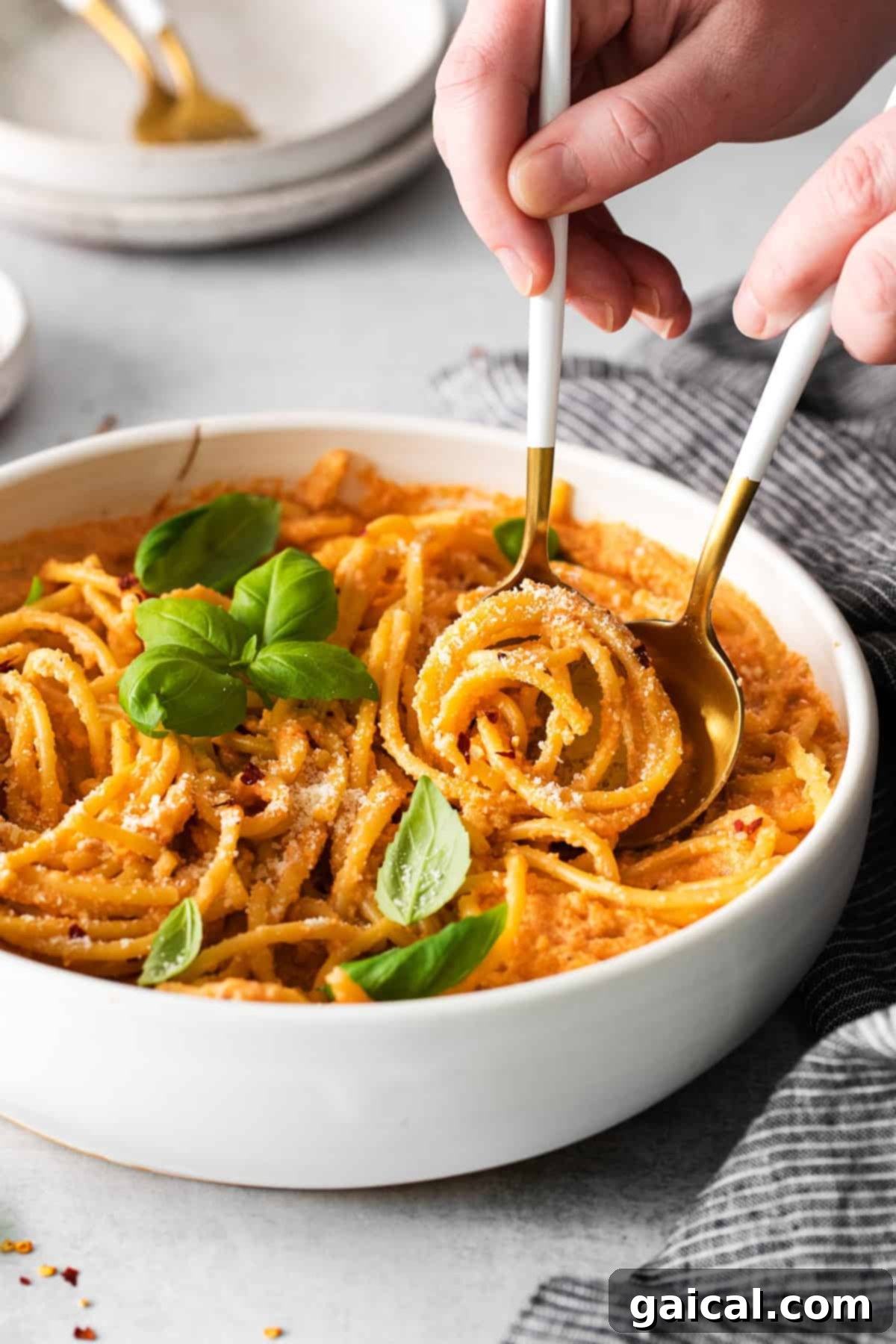 A bowl of creamy vegan pasta, garnished and ready to eat
