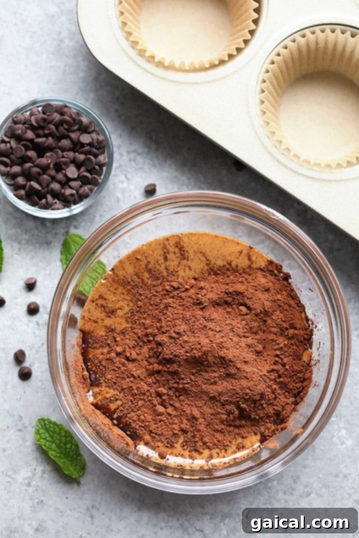 Fresh ingredients gathered for making healthy Thin Mint Almond Butter Cups. All wholesome ingredients in a bowl, ready to be mixed for Thin Mint Almond Butter Cups.