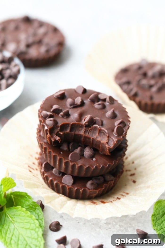 A delicious bite of a Thin Mint Almond Butter Cup, showcasing its perfect texture and minty chocolate goodness. Close-up of a Thin Mint Almond Butter Cup, showing its rich texture and delicious appeal.