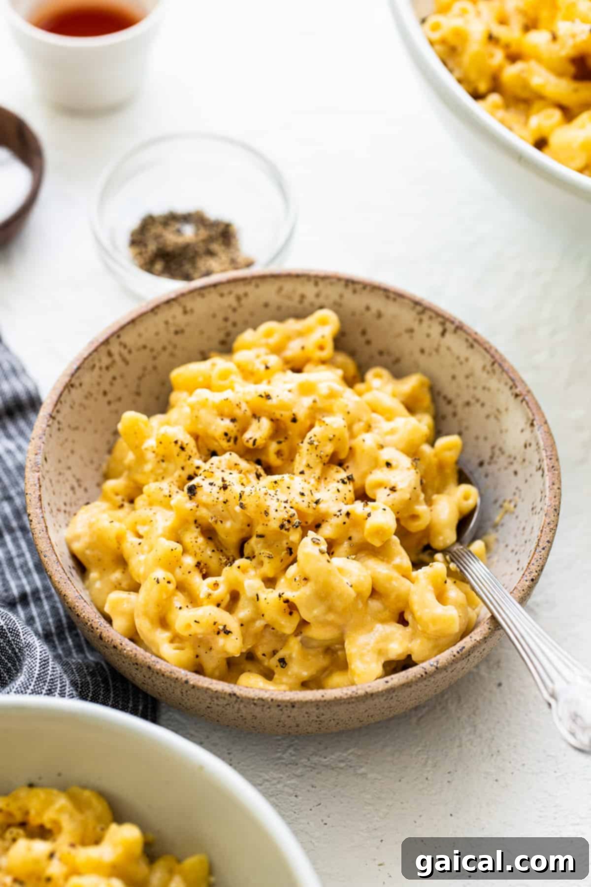Protein-Powered Instant Pot Mac 7 A bowl of Instant Pot Protein Mac and Cheese, generously topped with freshly cracked black pepper, highlighting its creamy texture.