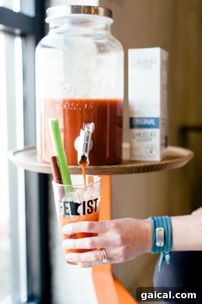 Bloody Mary Pouring into Cup - A refreshing drink from our Bloodys and Bouldering event, symbolizing celebration and connection.