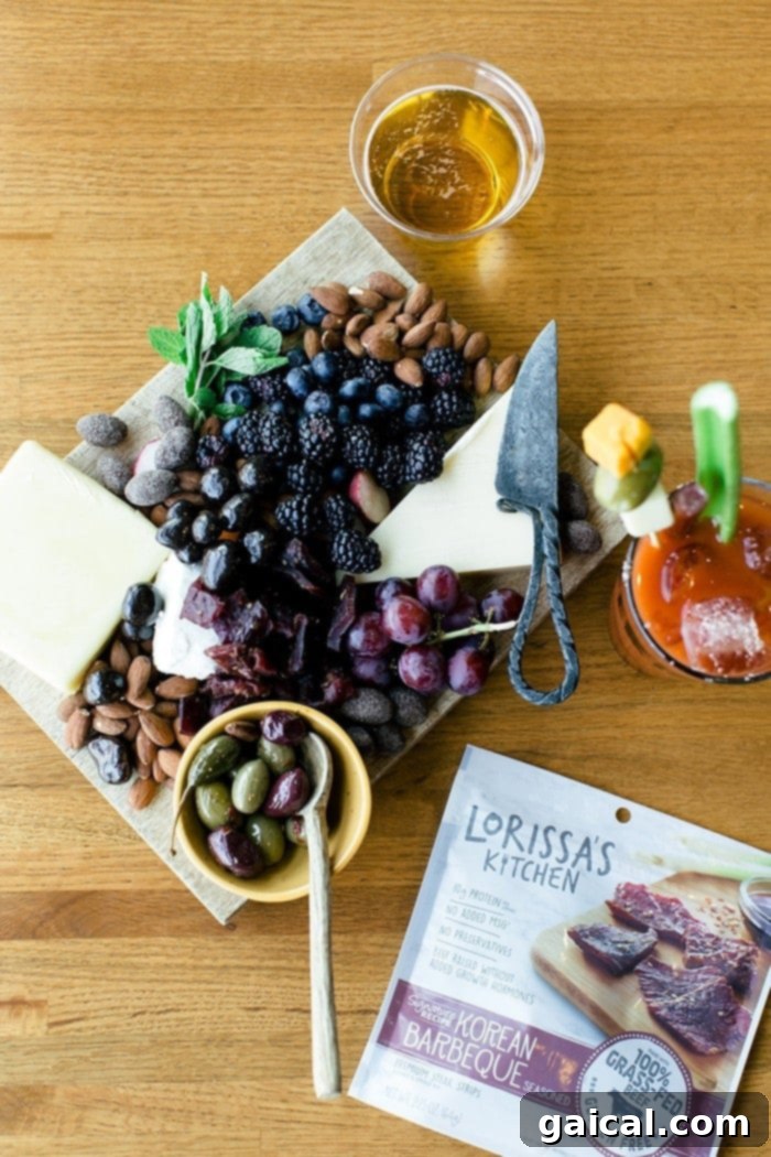 Charcuterie board overflowing with gourmet snacks, Lorissa's Kitchen beef sticks, cheeses, and fruits for healthy enjoyment.