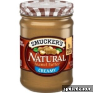 Ultimate Honey Peanut Butter Scotcheroos 2 A jar of our favorite natural peanut butter, perfect for healthy scotcheroos, set against a clean background.