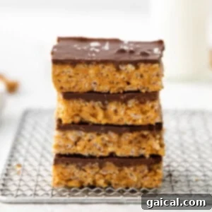 Ultimate Honey Peanut Butter Scotcheroos 3 Stacked scotcheroos on a plate.