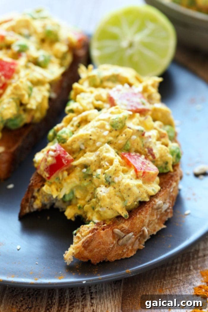 This Curry Chicken Salad is a healthy chicken salad recipe that the whole family will love! It's packed with flavor and protein and is a great meal-prep for lunch or for a busy weeknight meal. Give this easy chicken salad recipe a try today! A bite taken out of a curry chicken salad sandwich