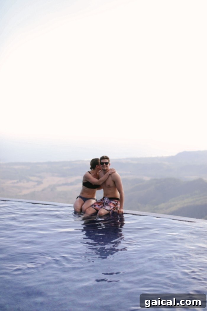 Relaxing in the infinity pool with panoramic ocean views in Guanacaste Couple enjoying the infinity pool overlooking the Costa Rican coast in Guanacaste