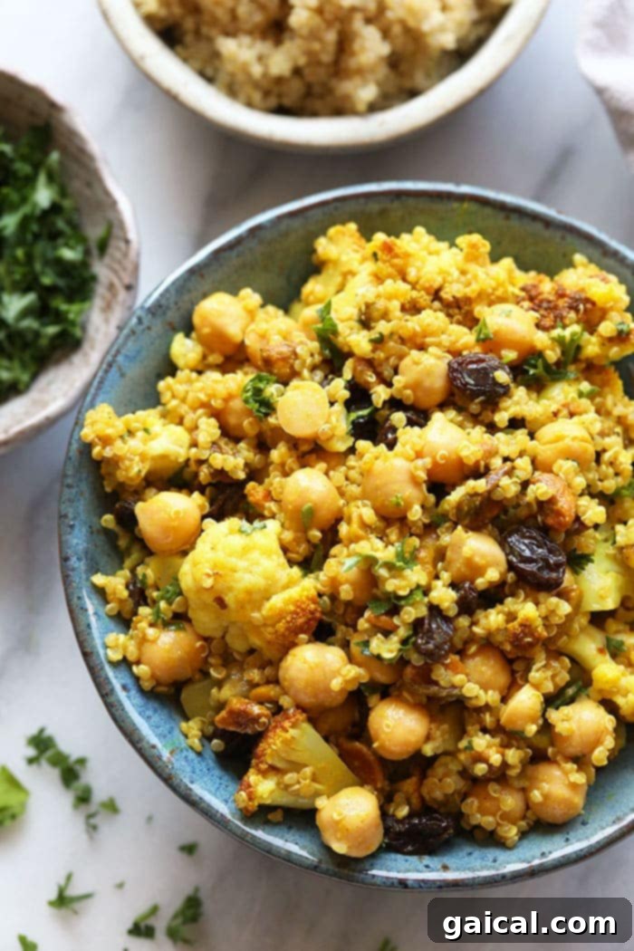 A single serving of the healthy Golden Roasted Cauliflower and Quinoa Salad in a stylish bowl, showcasing its colorful ingredients and creamy dressing.