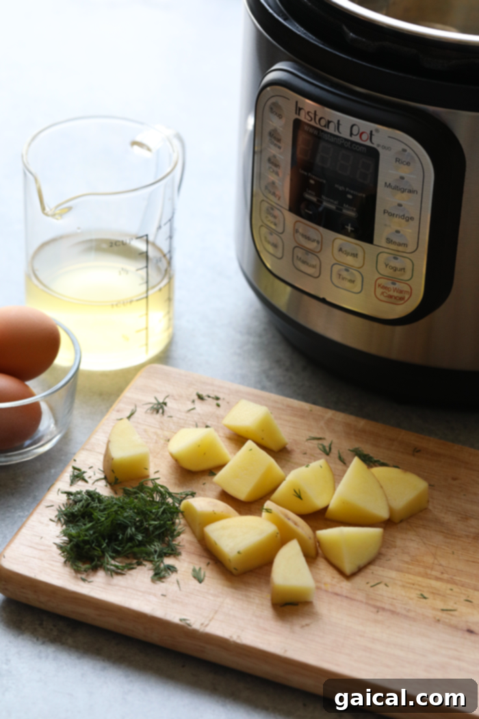Fresh and wholesome ingredients for a perfect Instant Pot Potato Salad. Fresh ingredients for potato salad including potatoes, eggs, dill, and pickles neatly arranged on a wooden cutting board.