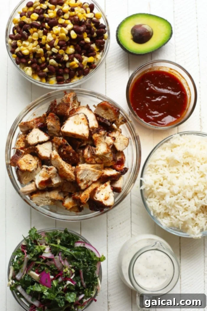 Meal-prep these bbq chicken bowls for a healthy lunch this week. You can make a big batch of slaw, grill your chicken, and make your corn mixture at the beginning of the week and you'll be all set! All the fresh ingredients for homemade BBQ chicken bowls laid out: chicken breasts, fresh kale, lime, cilantro, corn, black beans, and rice.