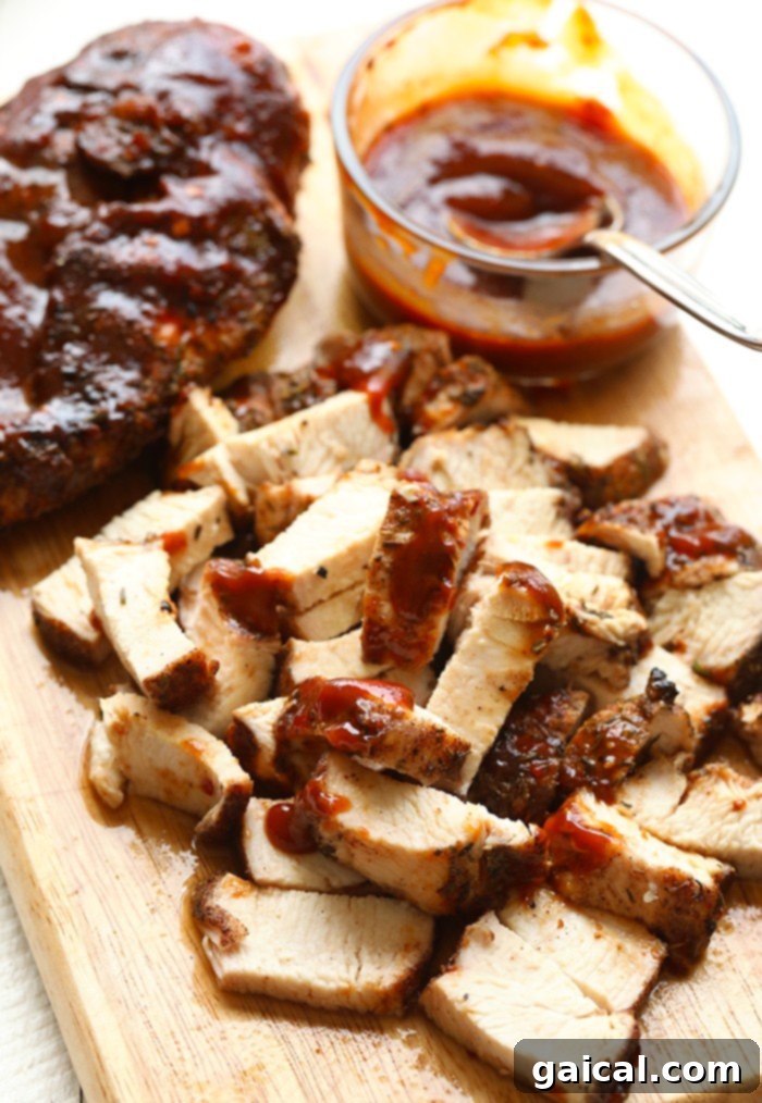 We love chicken meal prep on Fit Foodie Finds! These bbq chicken bowls are packed with flavor and ingredients that will get you excited to start up the grill! Three perfectly grilled chicken breasts on a cutting board, ready to be sliced for meal prep bowls. These BBQ chicken bowls are perfect for healthy meal prep.