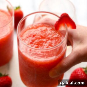 Easy Strawberry Peach Frosé Recipe A vibrant glass of strawberry peach frosé, perfectly blended and ready to serve, garnished with fresh fruit.