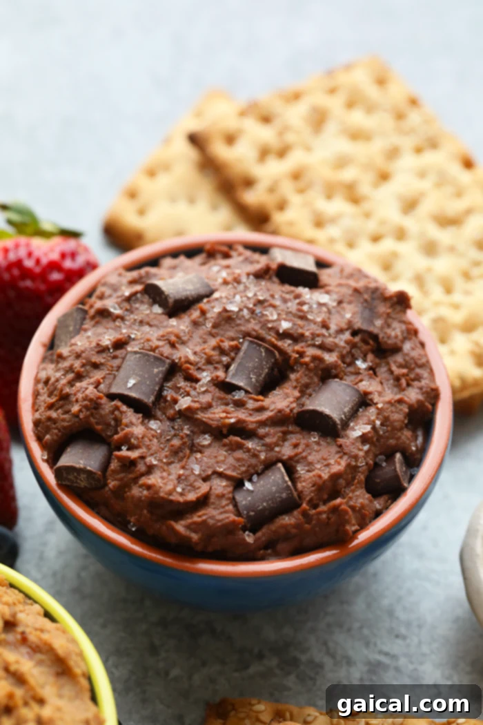 This chocolatey bowl of heaven is packed with protein and fiber thanks to a whole can of garbanzo beans. To make our Brownie Batter Sea Salt Edible Cookie Dough Dip, blend together garbanzo beans, cocoa powder, maple syrup, almond butter, and sea salt and you’ll be licking this bowl clean…no boxed brownie batter necessary! Bowl of rich Brownie Batter Sea Salt Cookie Dough Dip, sprinkled with flaky sea salt.