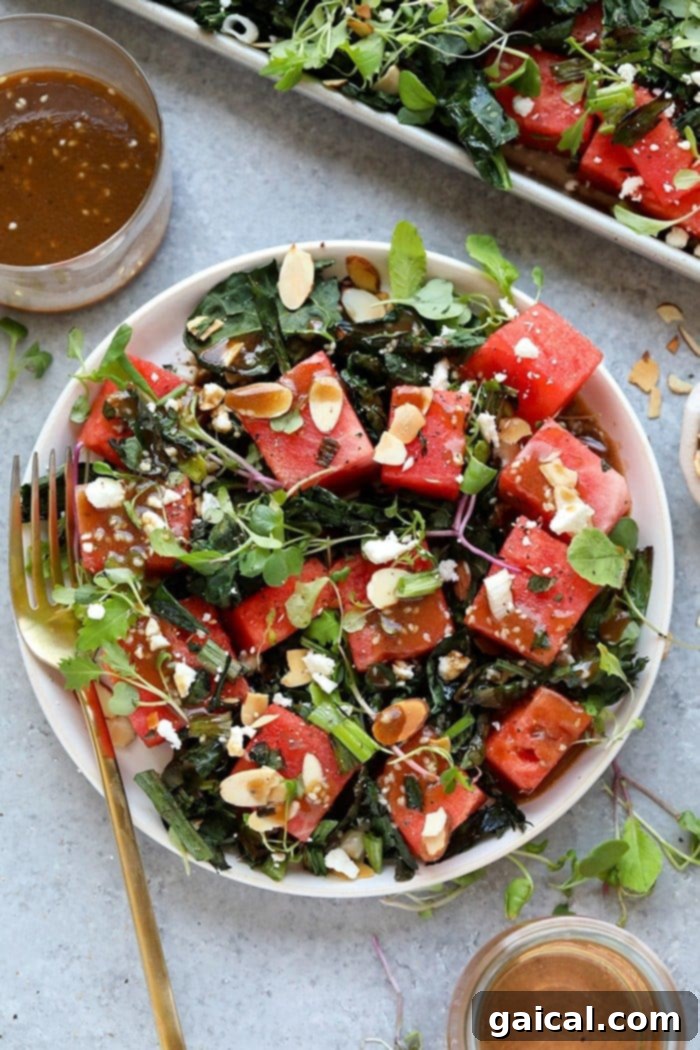 Grilled watermelon and kale salad artfully arranged on a plate, showcasing fresh ingredients and vibrant colors, perfect for a healthy summer meal.