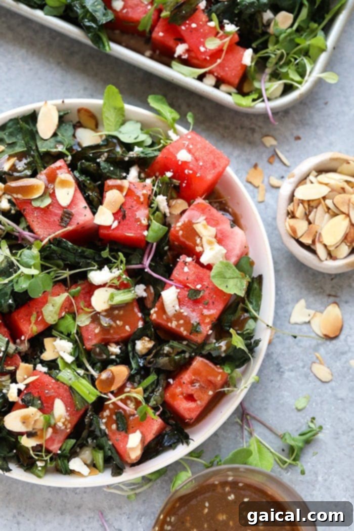 A vibrant bowl of Grilled Kale and Watermelon Salad, garnished with fresh microgreens and sesame seeds, ready to be enjoyed as a healthy, refreshing meal.