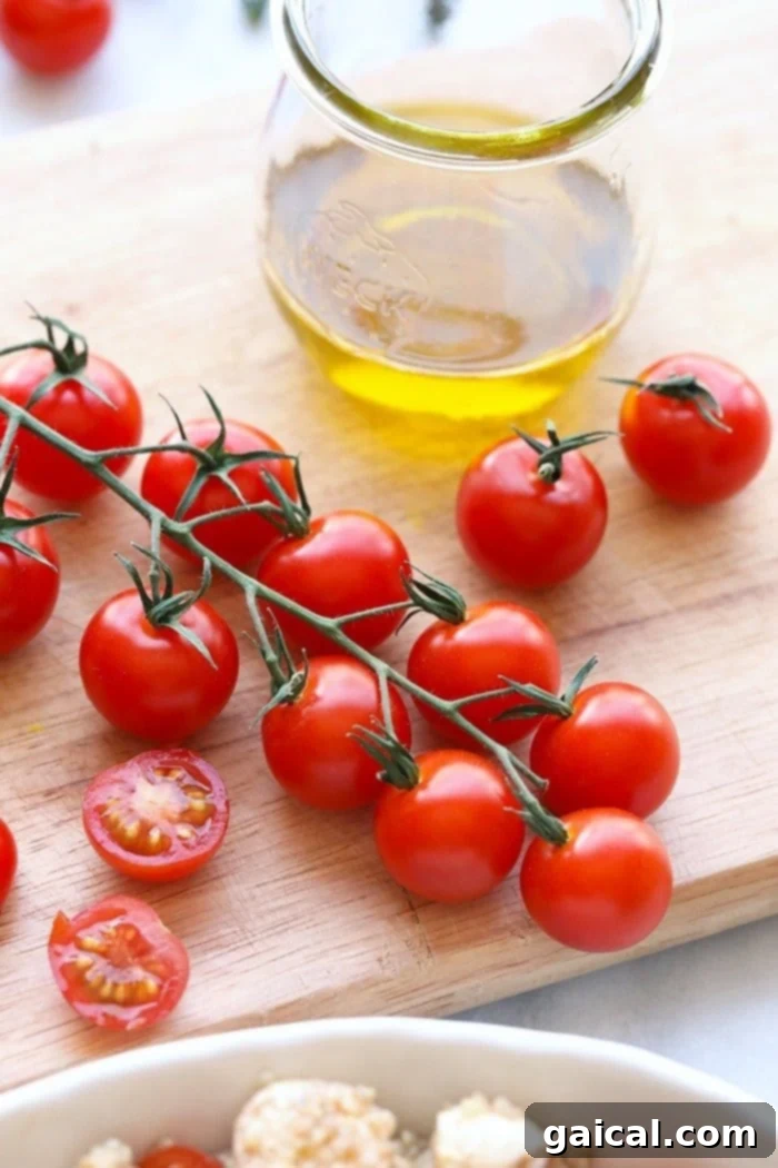 Close-up shot of vibrant, ripe fresh cherry tomatoes, perfectly halved and ready to be added to the Caprese Quinoa Salad.
