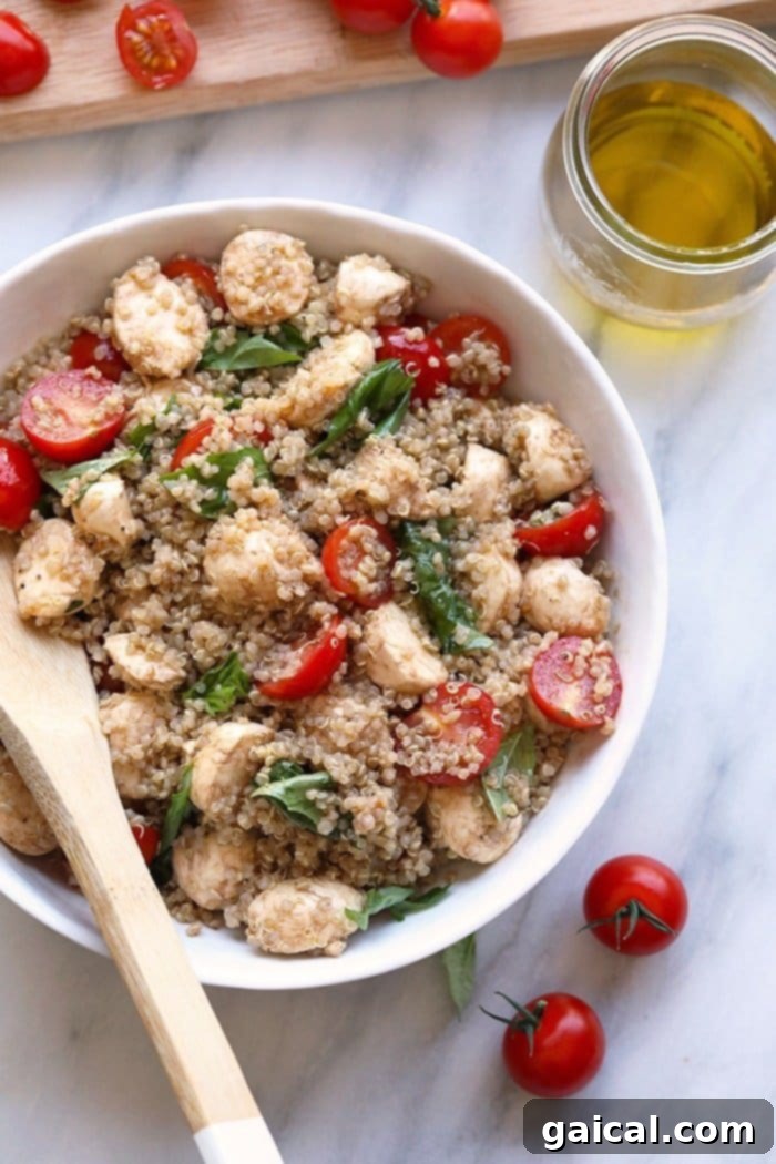 A large serving bowl filled with Fresh Caprese Quinoa Salad, perfectly mixed and ready to be enjoyed, showcasing a colorful array of ingredients.