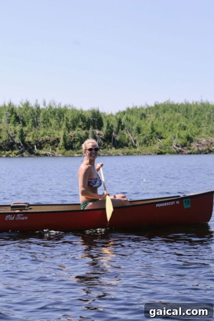 BWCA Canoeing Adventure Team Fit Foodie paddling through a scenic Boundary Waters lake