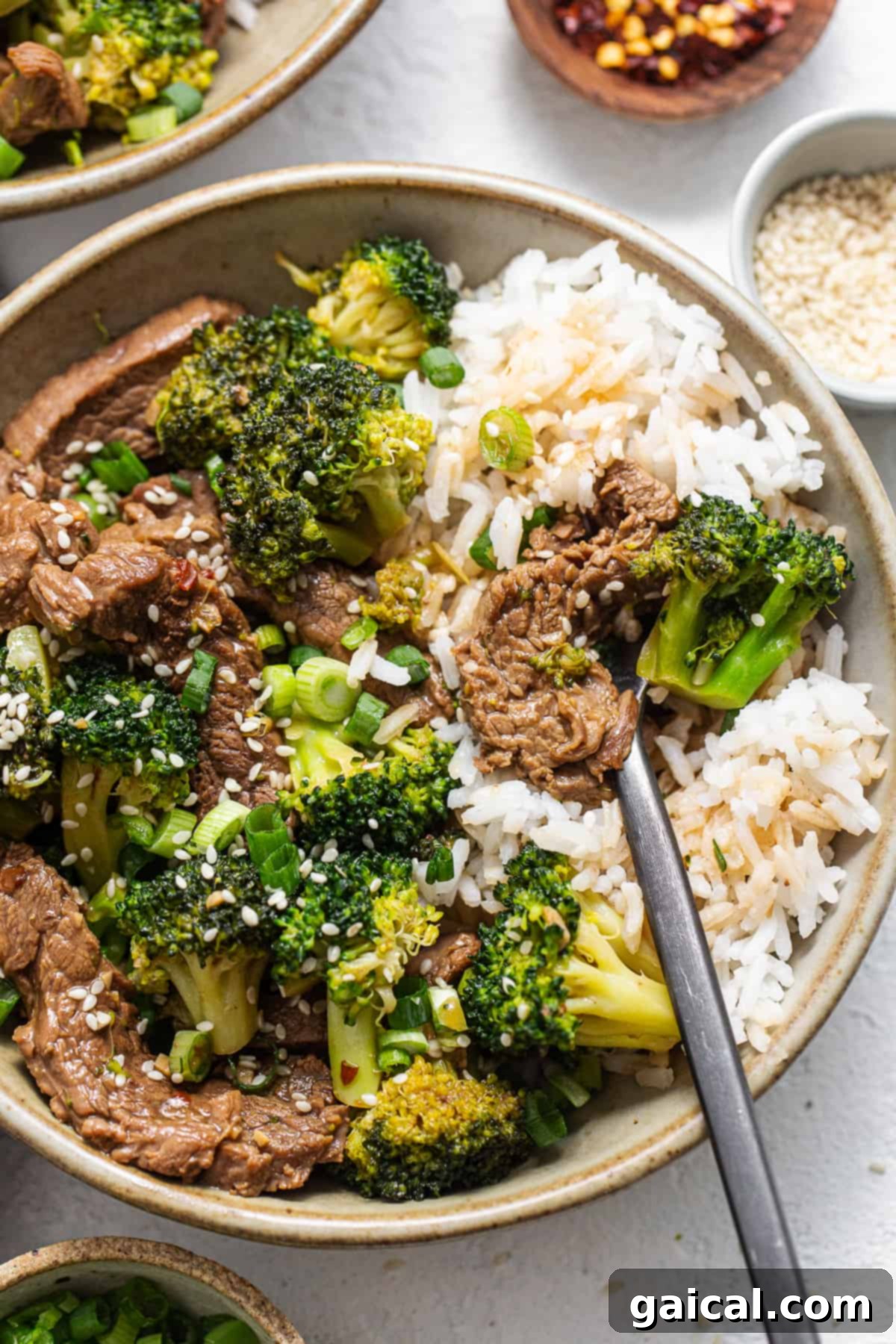 A vibrant bowl of Instant Pot Beef and Broccoli, showcasing tender beef, crisp green broccoli, and a rich, glossy brown sauce, ready to be enjoyed.