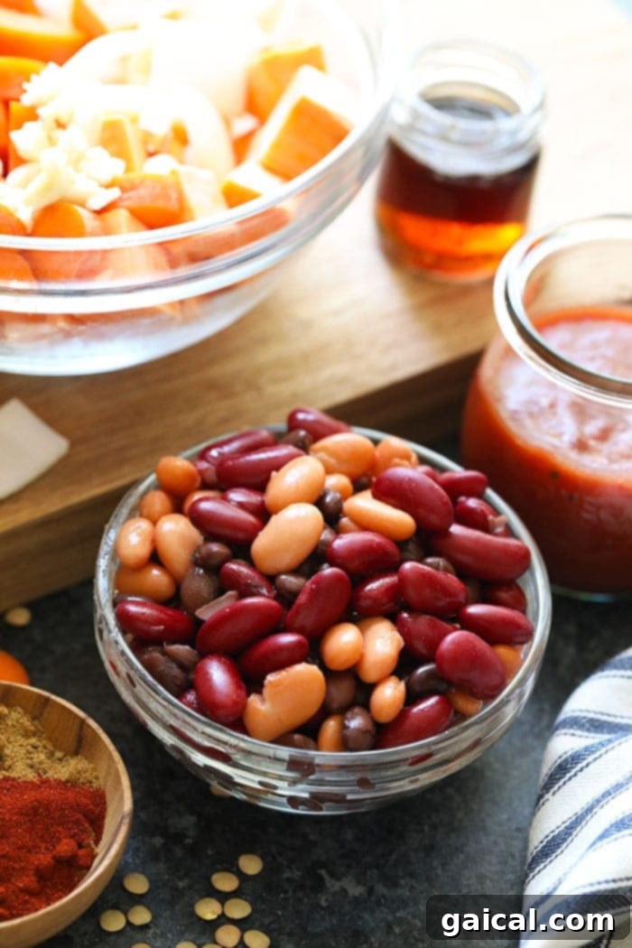 This Vegan Instant Pot Chili is an easy weeknight meal that everyone will love! It's packed with fiber from lentils and beans, as well as delicious veggies. This vegan Instant Pot Chili is the perfect meal-prep meal for the week. Make it now! Dried lentils and various canned beans in bowls, ready for the Instant Pot.