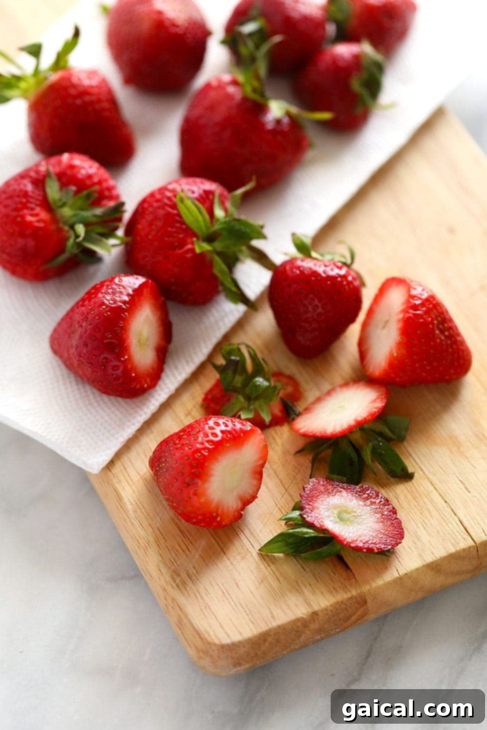 Drying Strawberries for Freezing Freshly sliced strawberries drying on a cutting board, ready for freezing