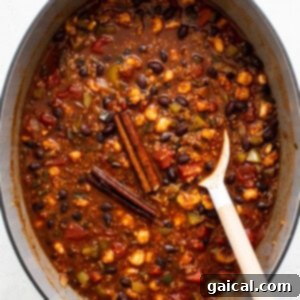 Cooked quinoa chili in a Dutch oven, ready for the final additions of broth and garnishes.
