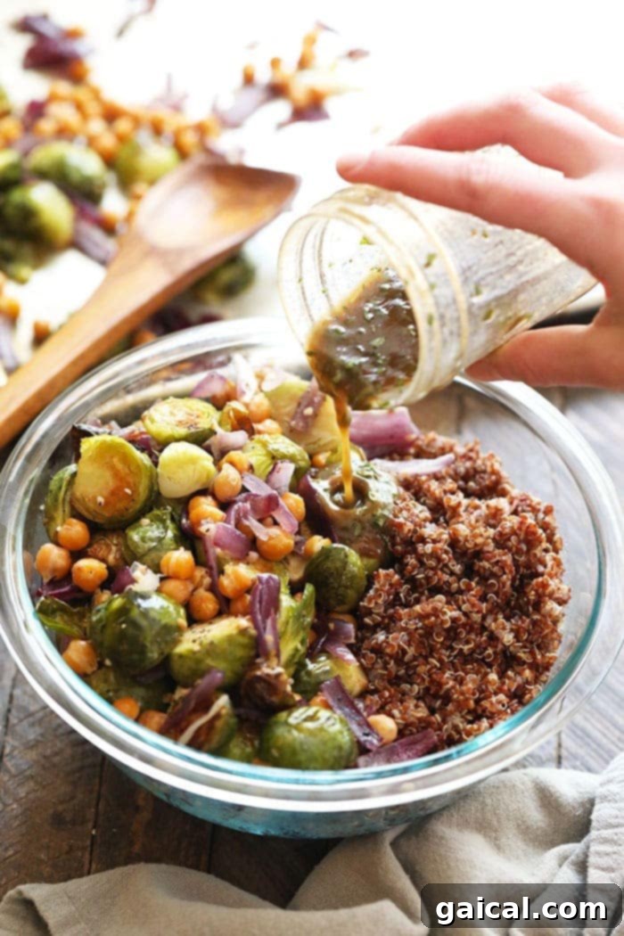 Pouring homemade balsamic dressing over a salad