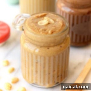 A jar of classic homemade peanut butter, showing its smooth texture.