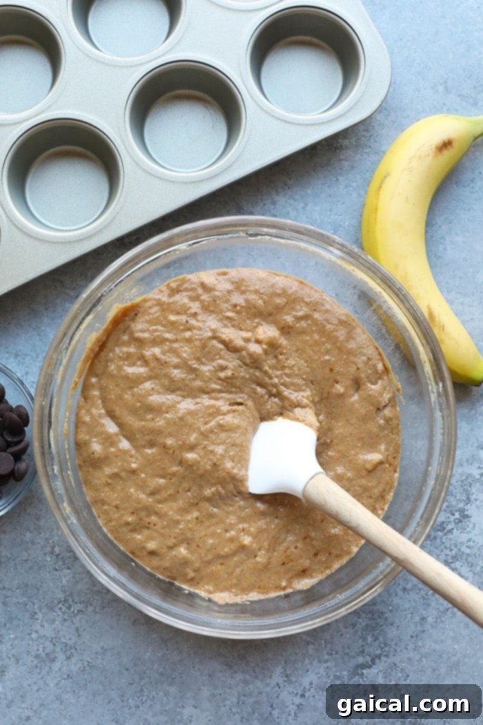 Mixing Banana Chocolate Chip Muffin Batter Banana chocolate chip muffin batter in a mixing bowl.